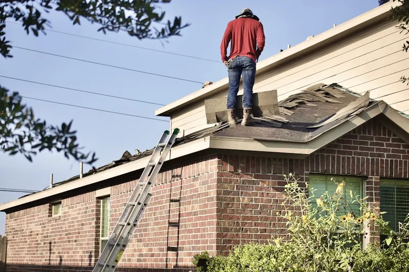 Professional roofer working on a residential roof in Northwood Harbor